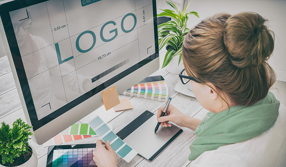Female creating logo on imac