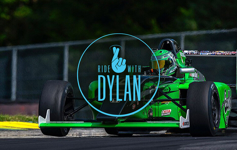 A green race car on a track with the logo 'Ride with Dylan' superimposed.