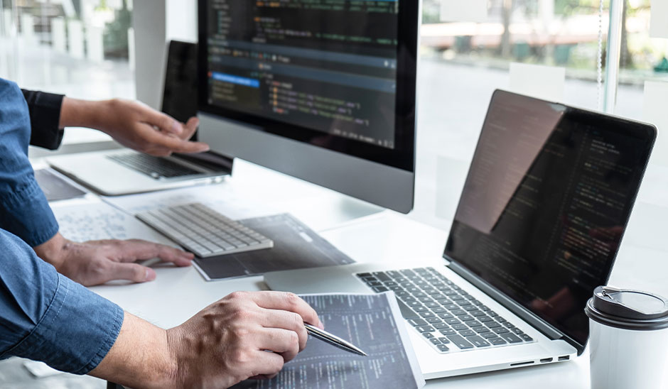 People on computer coding a website