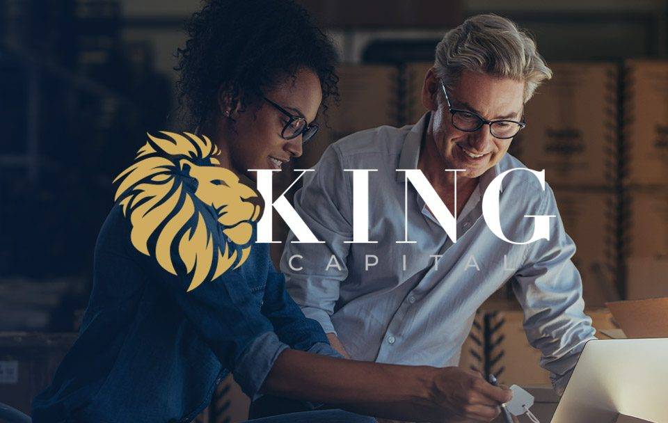 Two professionals collaborating over a laptop, with King Capital logo visible.