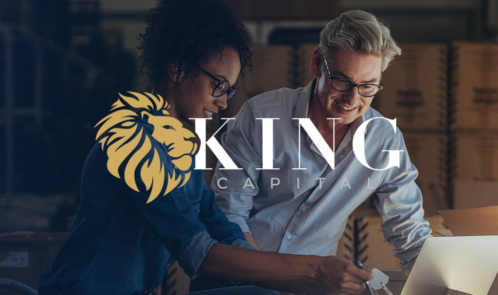 Two professionals collaborating over a laptop, with King Capital logo visible.