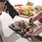 photography | Idea Stream Marketing A photographer captures vibrant vegetables and herbs on a wooden cutting board.