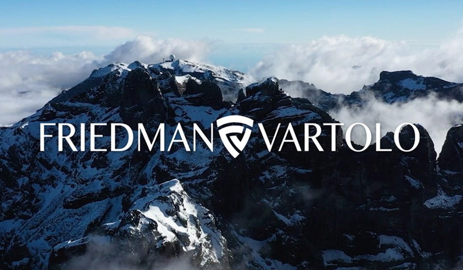 Friedman Vartolo logo overlaying a snowy mountain landscape under a clear blue sky.
