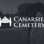 Gravestones and a statue in Canarsie Cemetery with the cemetery name prominently displayed.