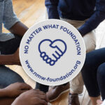 Group of people with a circular logo for No Matter What Foundation featuring a handshake.