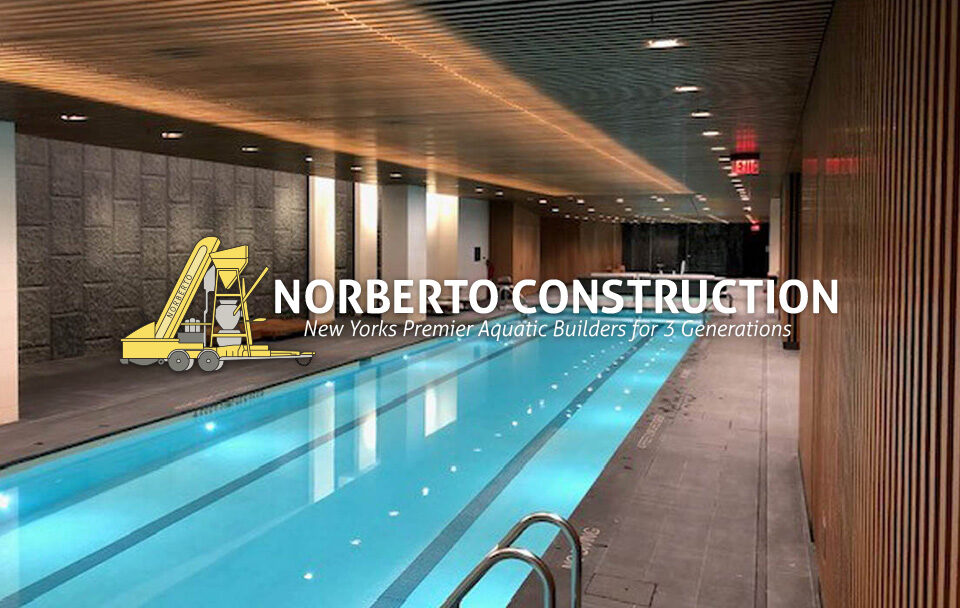 Modern indoor swimming pool by Norberto Construction featuring wooden paneling and a sleek design.
