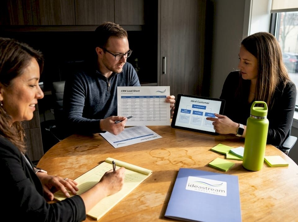 Small business team discussing lead generation strategies at a conference table.