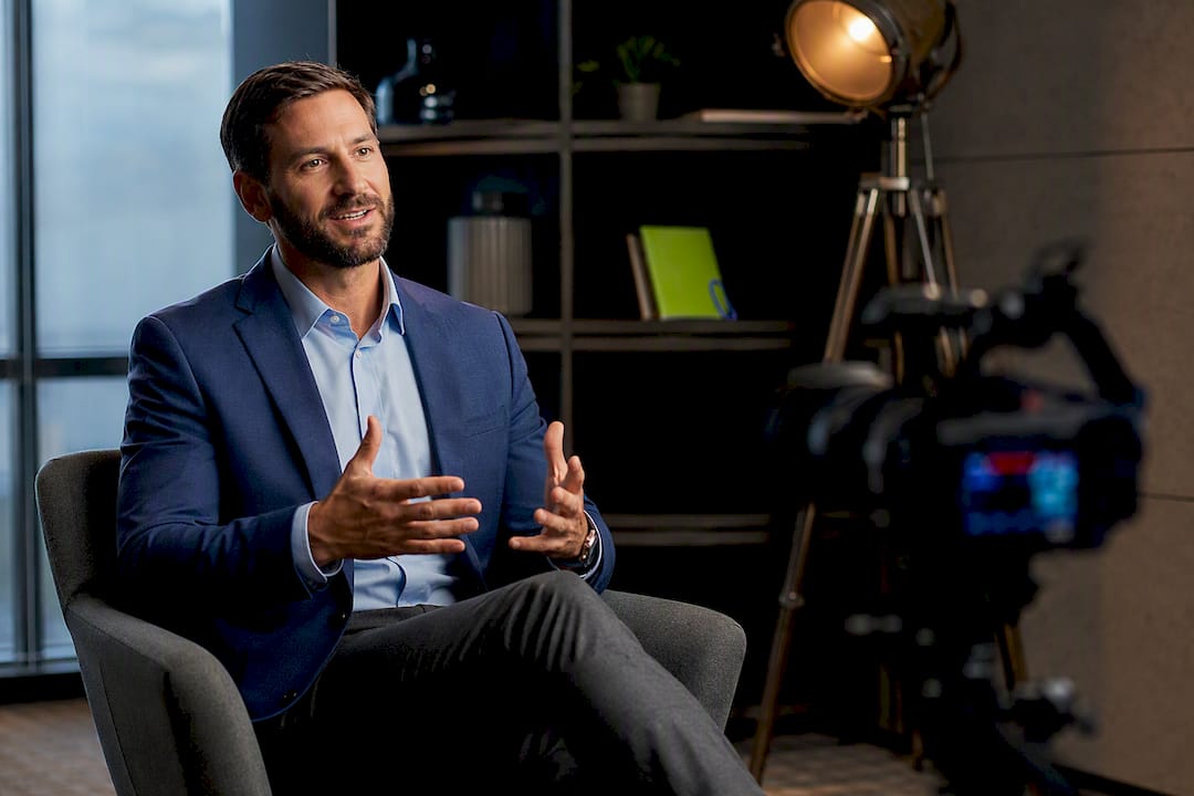 Business Professional Testimonial Interview | Idea Stream Marketing Business professional engaged in a testimonial interview, gesturing while speaking.