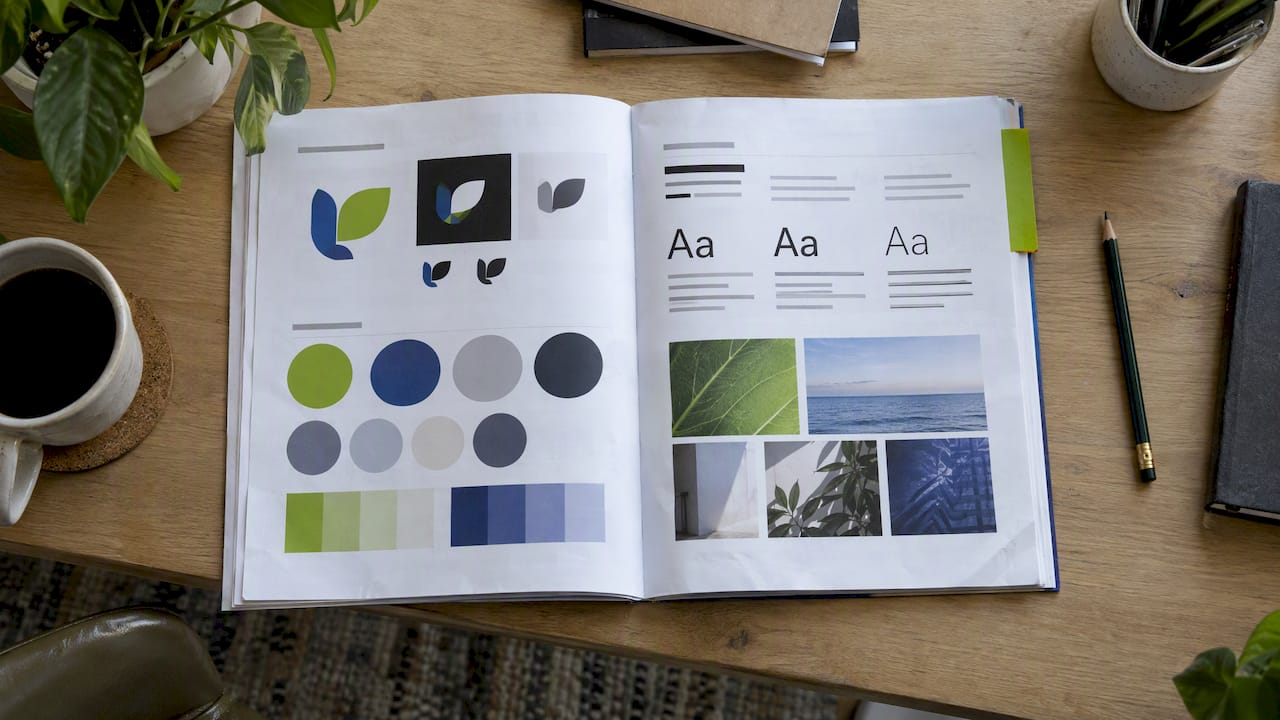 Open brand guidelines booklet with color swatches